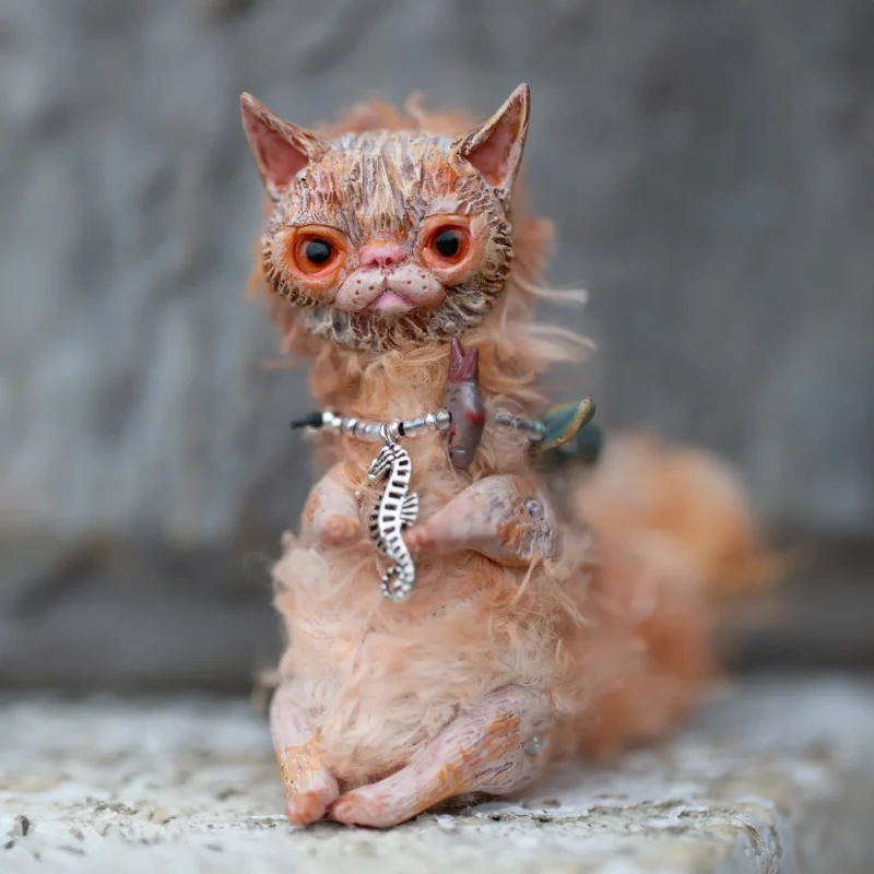 Кукла рыжий кот. Мордочка и лапки выполнены из полимерной глины, тельце из ткани. На шее у него ожерелье из пузырьков-бусинок и разноцветных рыбок.